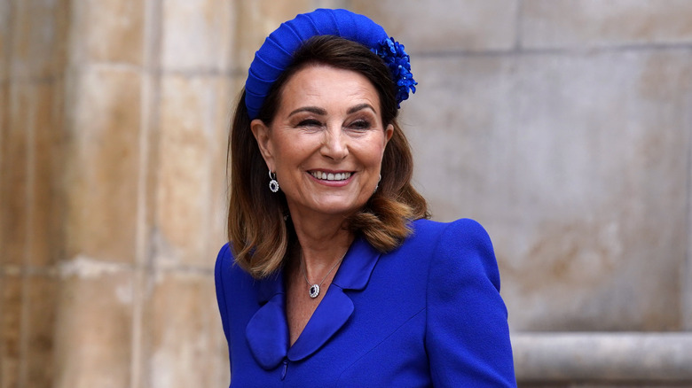 Carole Middleton smiling in blue outfit outside Westminster Abbey