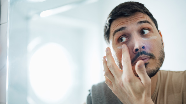 Man applying eye cream