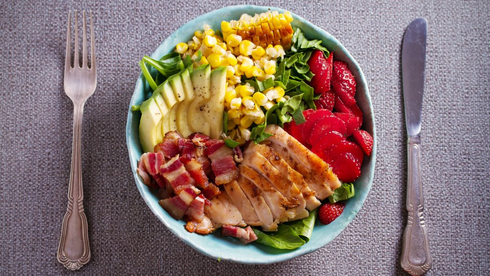 A Cobb salad from above with silverware, a favorite of Christina Anstead's