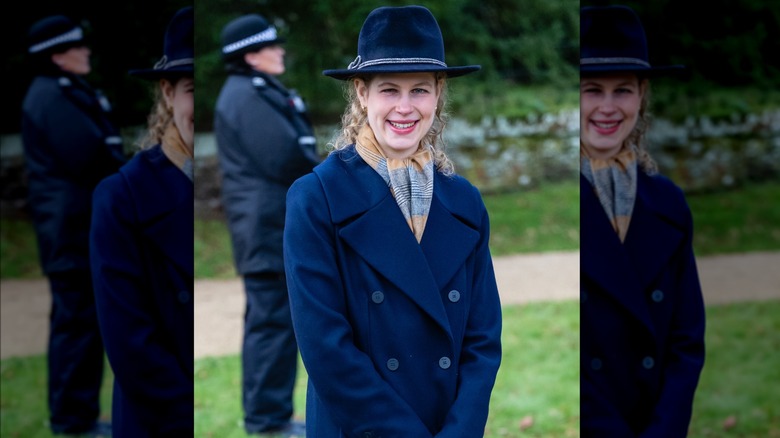 Lady Louise smiling in blue coat and hat