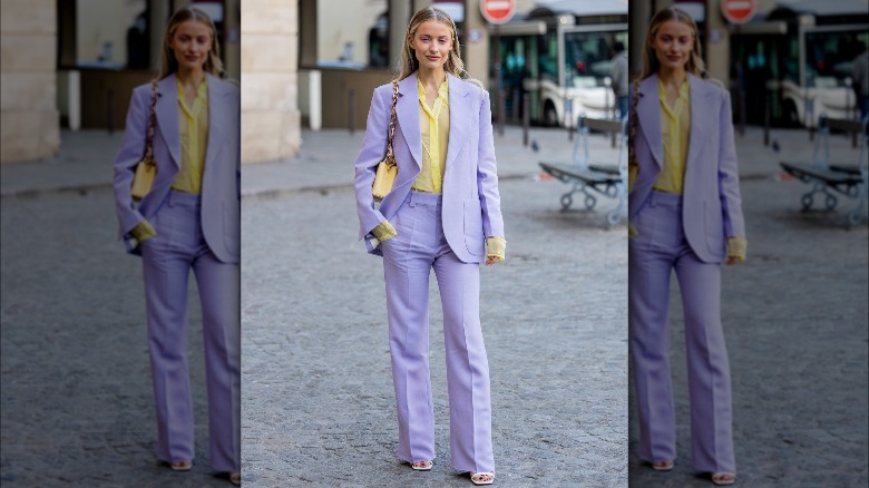 Woman in lavender suit and pastel yellow shirt