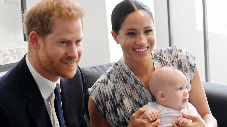 Prince Harry and Meghan Markle holding their son, Archie 