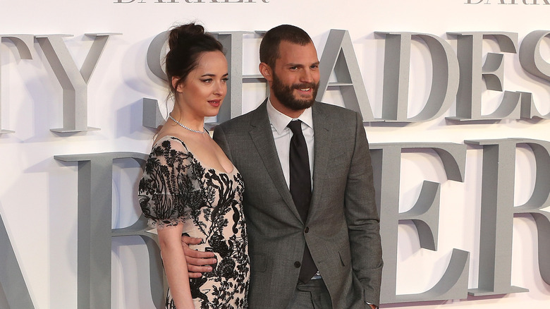 jamie dornan and dakota johnson smile at premiere