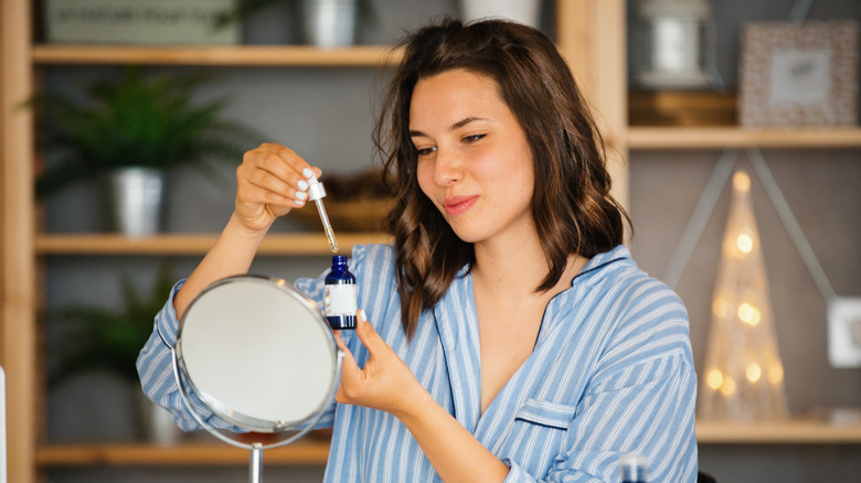 Woman using dandelion oil