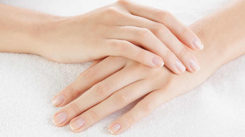 Hands folded on a towel