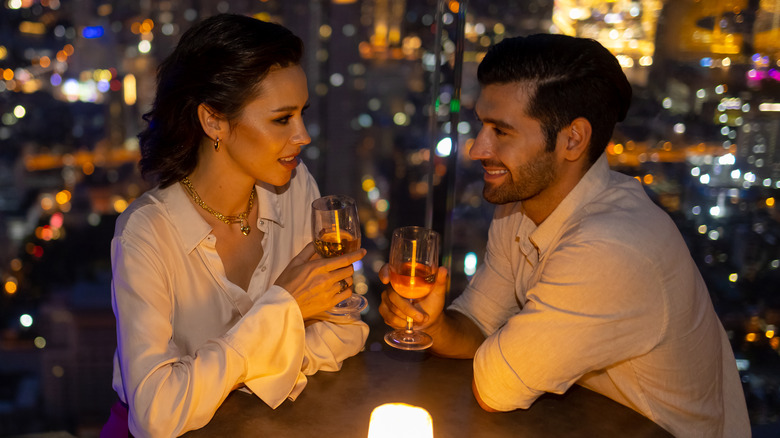 couple on date a rooftop bar