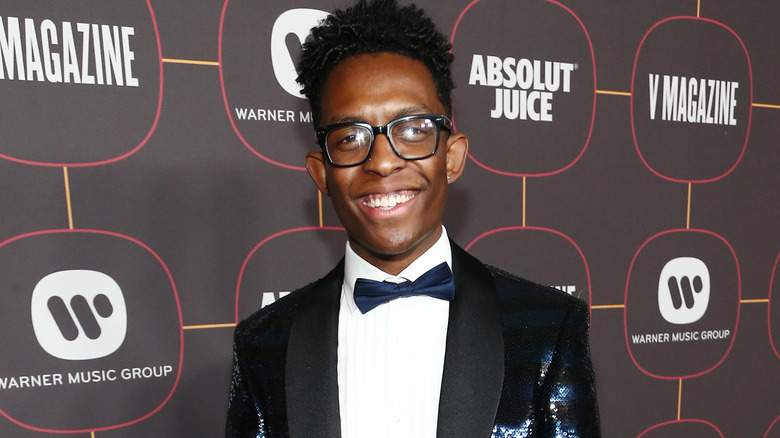 Breland smiles in a sequined blue suit and bow tie