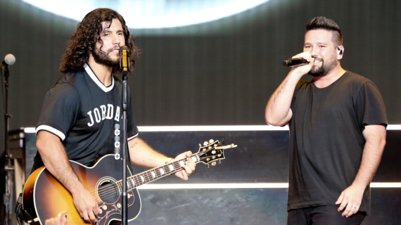 Dan + Shay singing at a concert