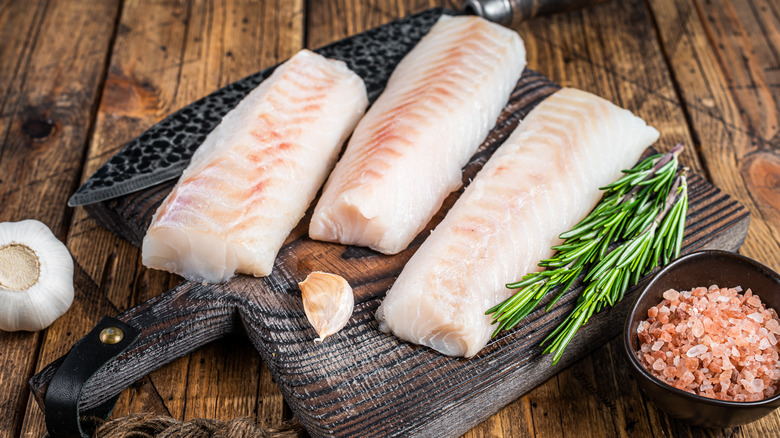 Cod on a cutting board with salt