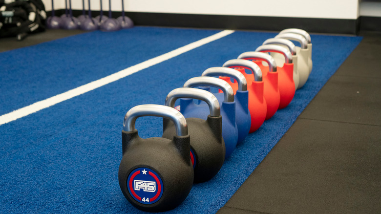 Kettle bells lined up at an F45 gym 