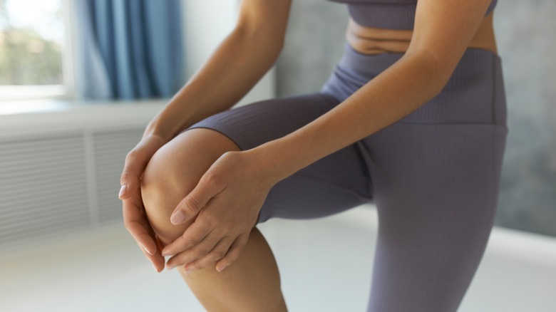Woman holding her bent knee