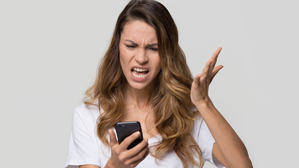 Angry woman yelling at phone 