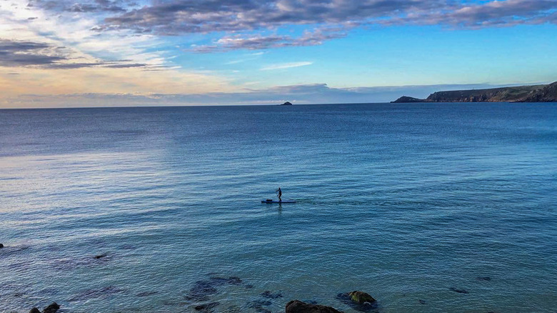 paddle boarder on calm ocean