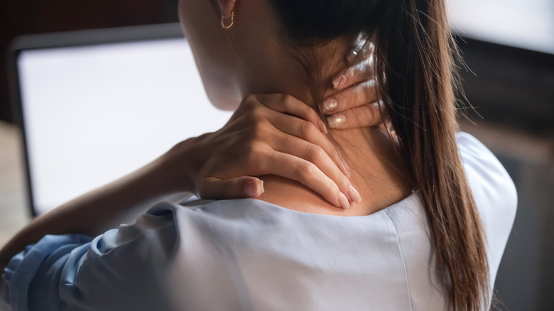 Woman experiencing pain in her neck