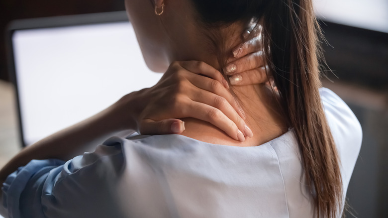 Woman experiencing pain in her neck