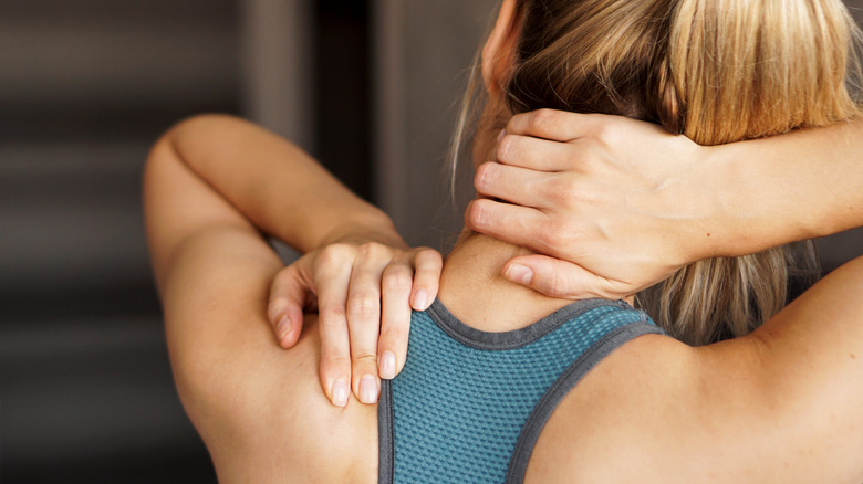 A woman experiencing muscle strain