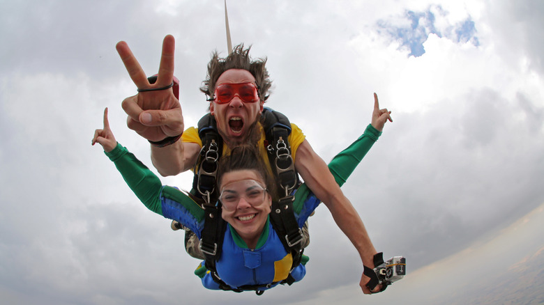 Woman and man sky diving