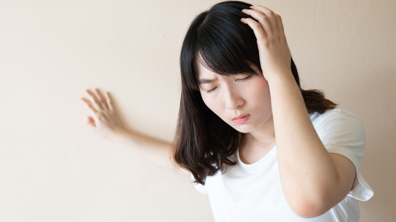 Woman feeling dizzy standing up 