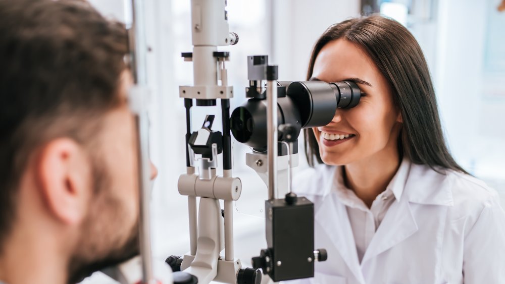 An eye doctor examining her patient 