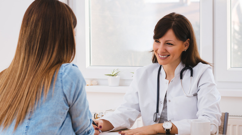 Woman consulting with her doctor in an office.