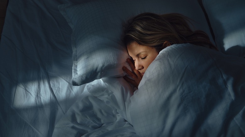 Woman sleeping under blankets