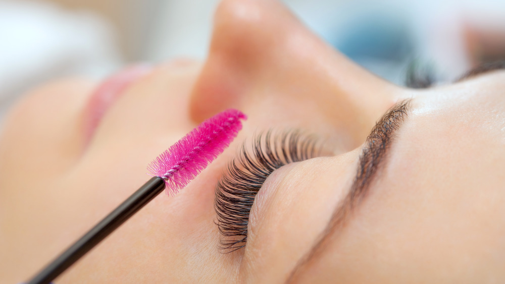 Woman using an eyelash wand