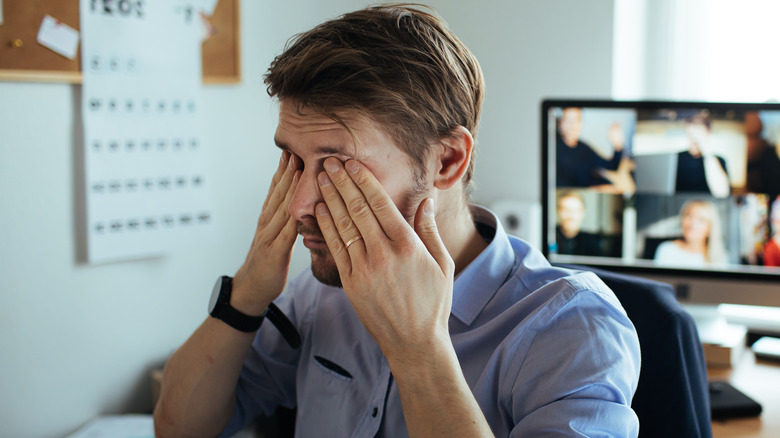 Man rubbing eyes with hands 