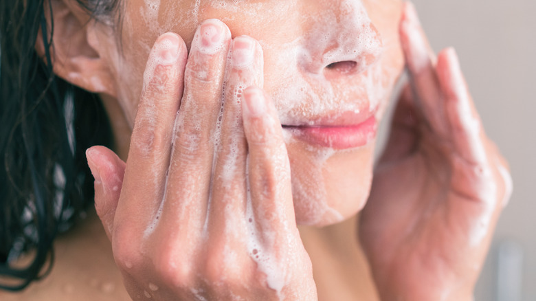 Woman applying exfoliant