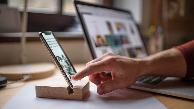 Man using a phone stand holder to prevent wrist pain