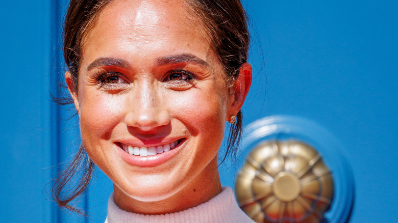 Meghan Markle poses at an event.