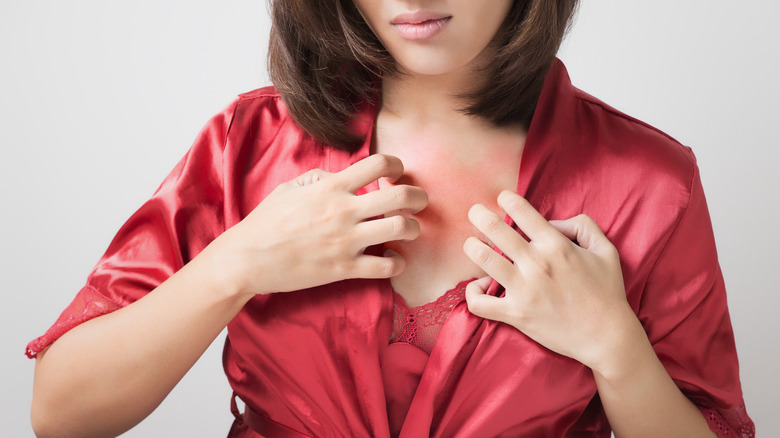 Woman suffering from an itchy chest 