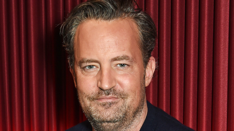 Matthew Perry crosses his arms