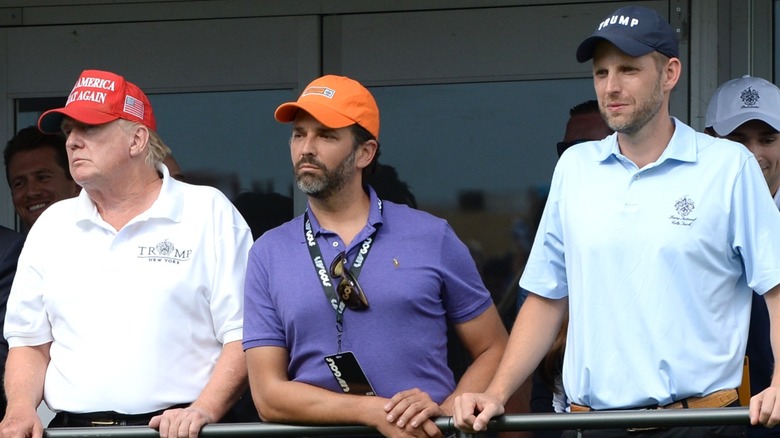 Donald Trump, Donald Trump Jr., Eric Trump staring to the side