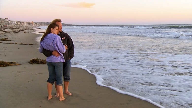 Robyn and Kody Brown embracing on the beach