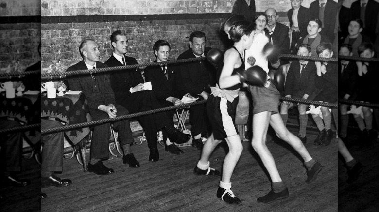 Prince Phillip watching a boxing match