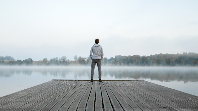 Young man standing on dock