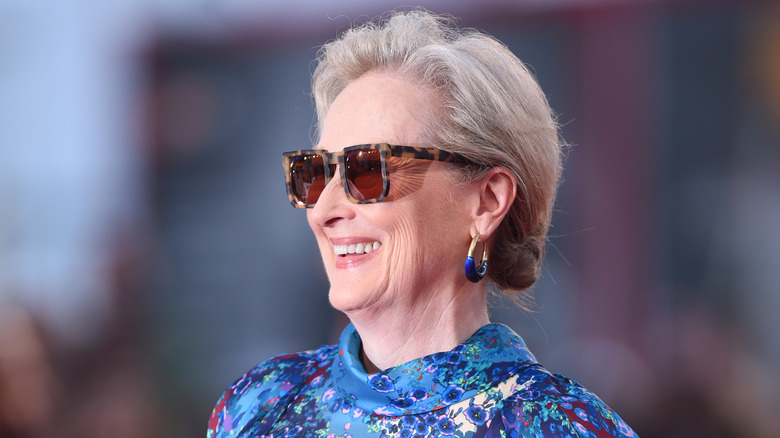 Meryl Streep smiling in sunglasses at event