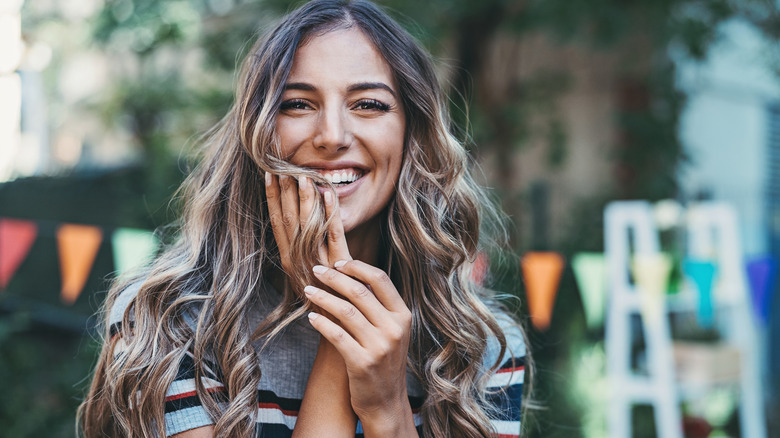 Woman outside with long ombre wavy hair 