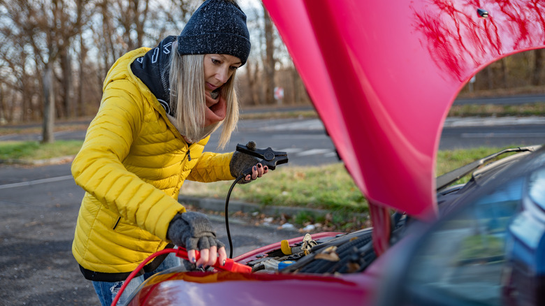 Woman with jumper cables