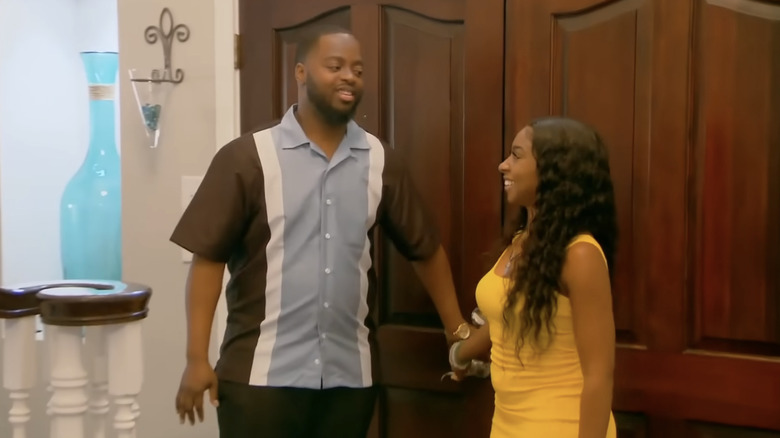 Couple examining foyer on "House Hunters"