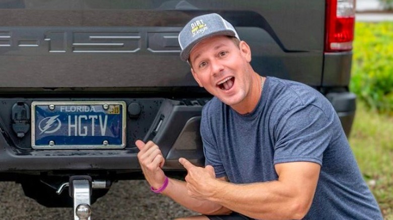 Brian Kleinschmidt posing with license plate