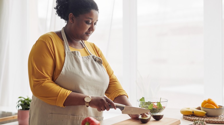 woman cutting an avocado