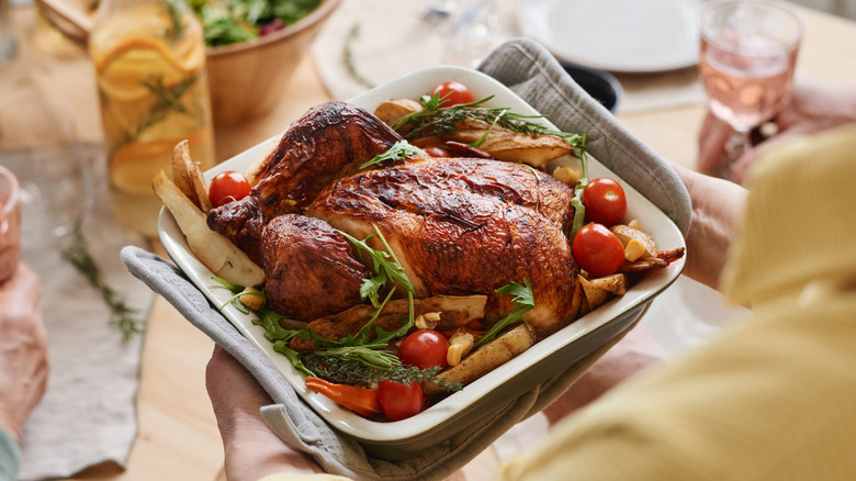 woman serving chicken dinner