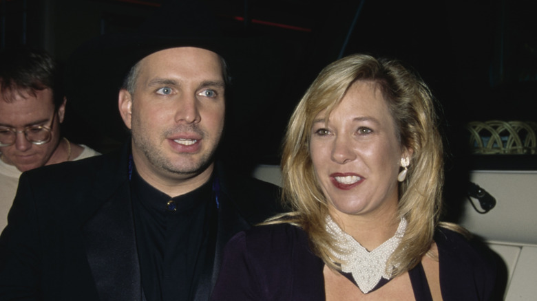 Garth Brooks wearing black cowboy hat and Sandy Mahl wearing pearl earrings