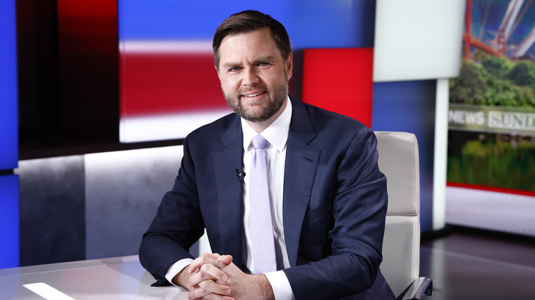 JD Vance sits at a desk