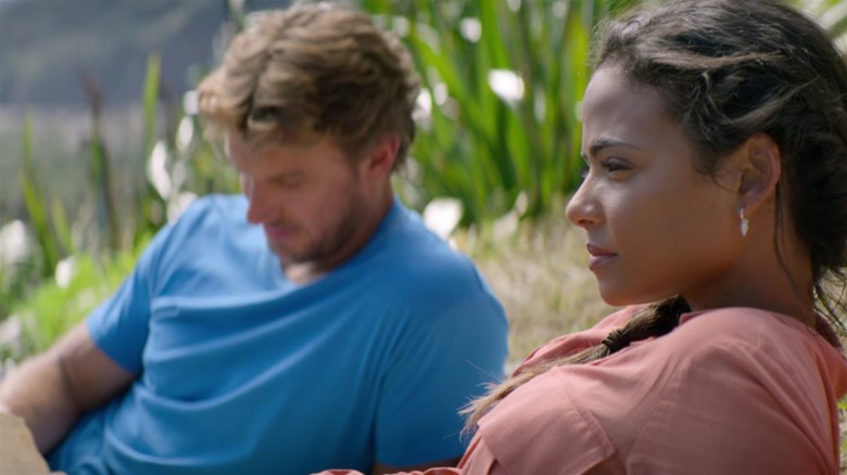 Christina Milian and Adam Demos reclining in Falling Inn Love