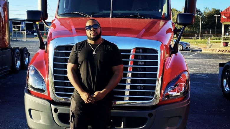 Alashe Nelson in front of his semi-truck