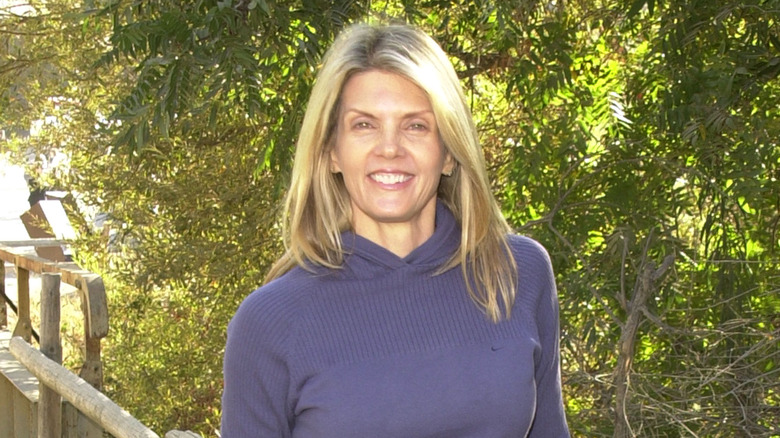 Kathy Smith smiling in front of trees