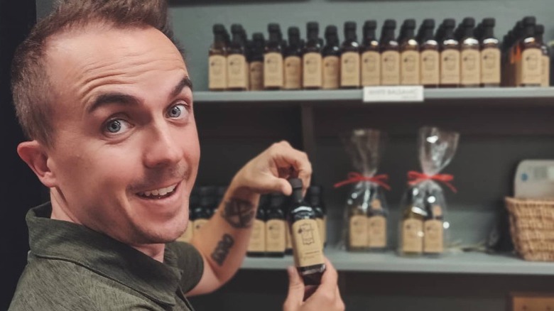 Frankie Muniz holding olive oil bottle