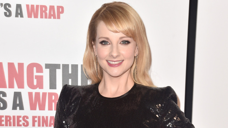 Melissa Rauch smiling on step-and-repeat